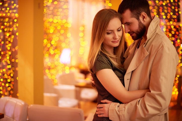 Loving couple embracing in restaurant while saying goodbye