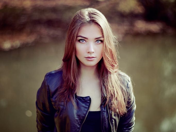 Portrait of young beautiful woman in leather jacket. Fashion photo