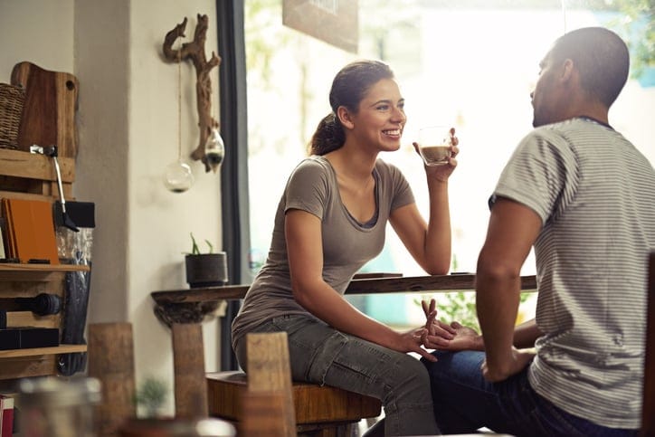 Shot of a young couple enjoying their date at a local coffee shop