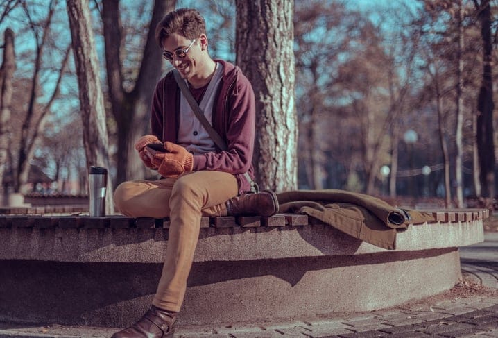 Urban young boy chatting in the park