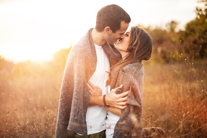 Portrait of a loving couple wrapped in a blanket