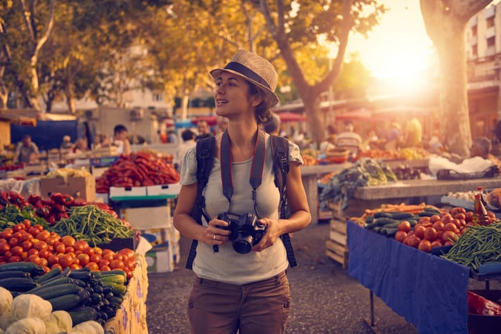 Shot of a woman taking photos while exploring a foreign city