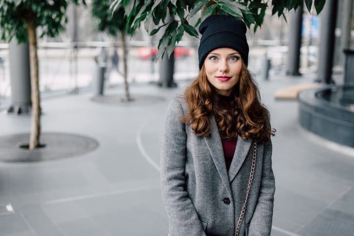 Woman standing on the street with blur background and smileWoman standing on the street