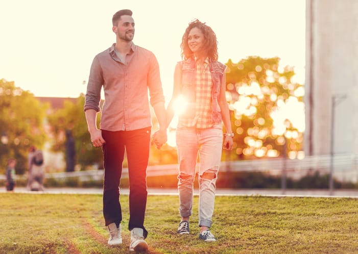 young couple happy walking sunset