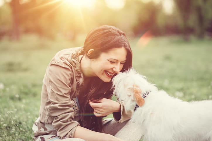 Young girl outside having fun with a dog