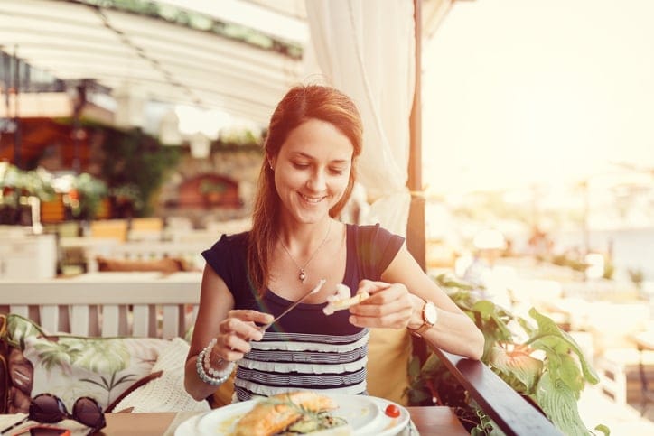 Smiling woman enjoying a lunch in restaurant