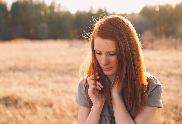 young redhead woman field portrait
