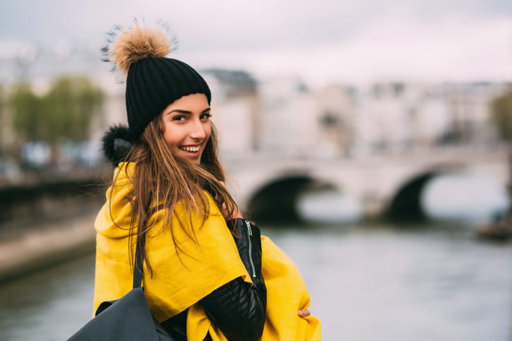 Portrait of a happy woman near by the Seine river in Paris.
