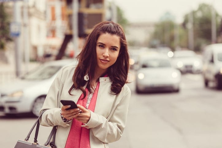 Young woman in a hurry waiting for a taxi
