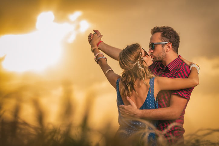 Couple enjoying outdoors in a wheat field.