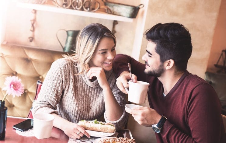 Handsome loving couple flirting in a cafe. Love and romance. Lifestyle concept