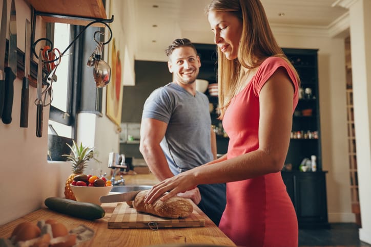 young couple in kitchen cooking food
