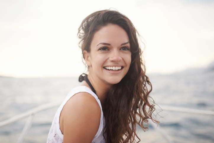Young brunette enjoying a summer sail