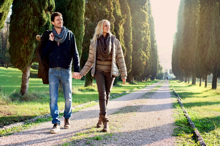 couple walking in the leafy avenue