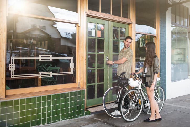 Australian mid adult couple locking their coffee shop business