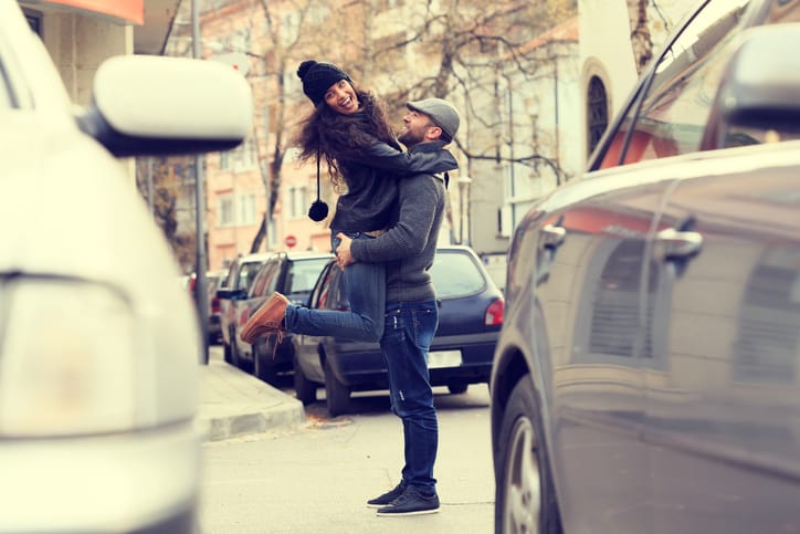 Young couple carrying and laughing