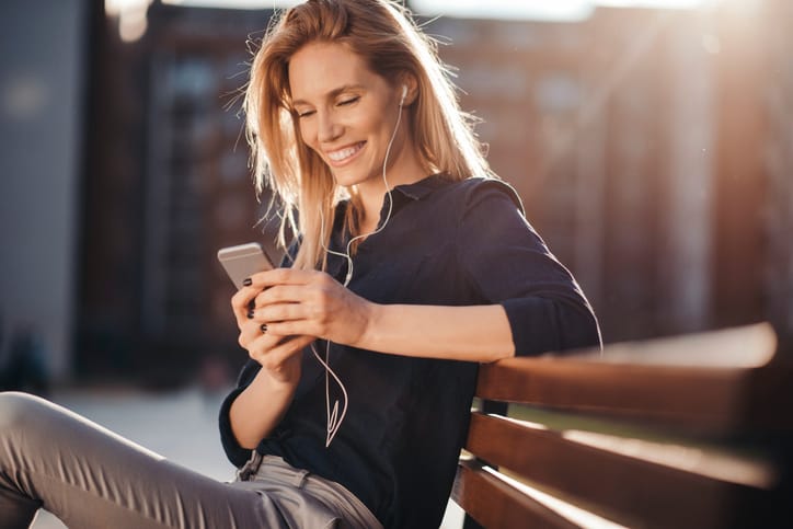 young woman texting park outdoors