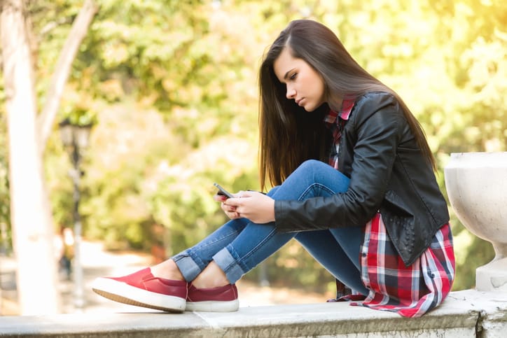 young woman sad depressed outdoors