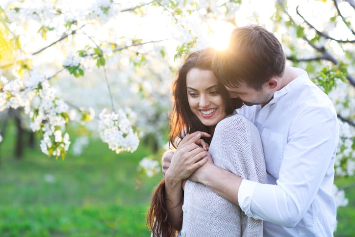Young couple in love kissing and hugging in nature