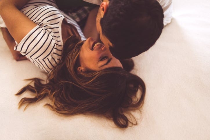 young couple happy kissing bed sex romance