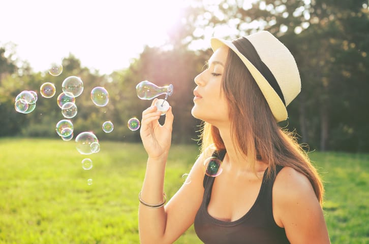 young woman bubbles summer outdoors