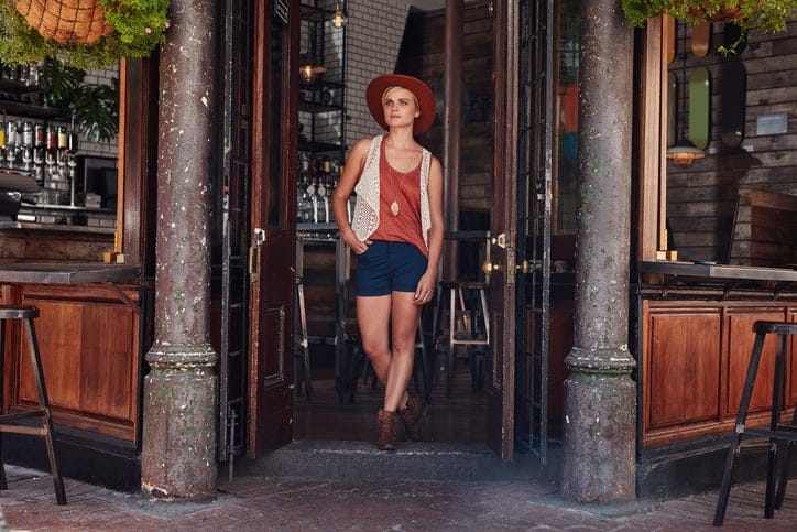 Stylish young woman leaving coffee shop