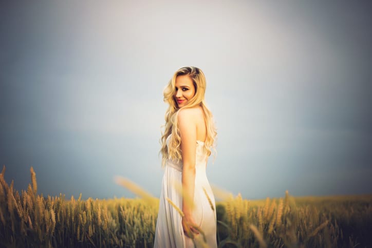 Beautiful blonde in white dress enjoying summer day outdoorsB