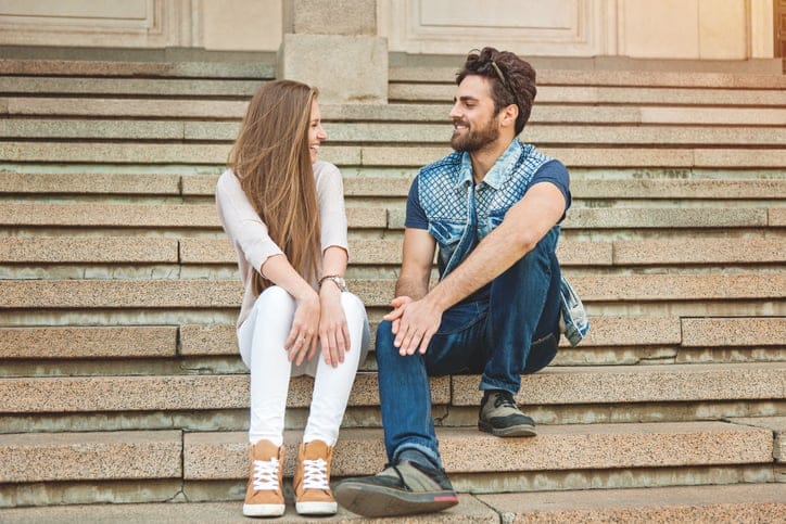 couple relaxing on staircase and talking