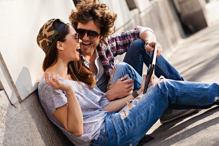 Close up of a happy young couple looking at digital tablet