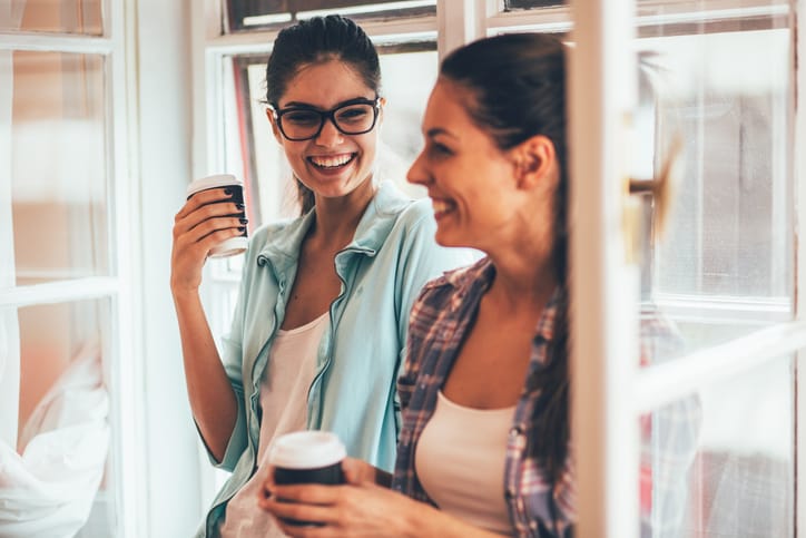 Two friends relaxing and drinking coffee .Coffee break.Coffee to go.