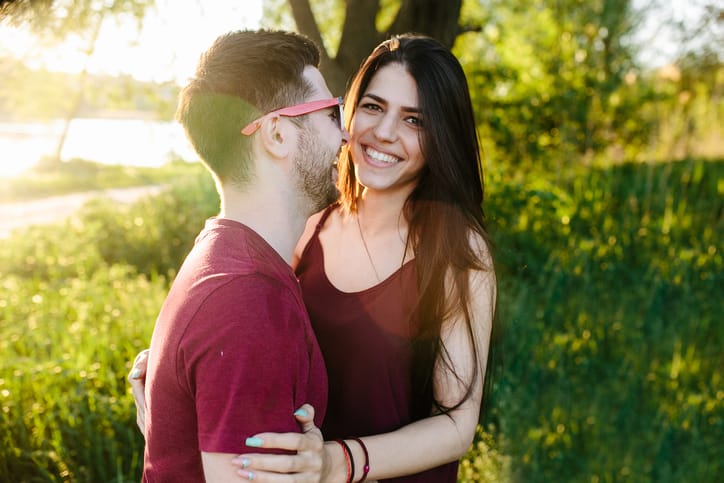 Young beautiful couple having fun in the nature of the countryside