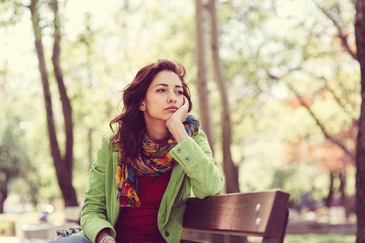 Thoughtful woman in the park