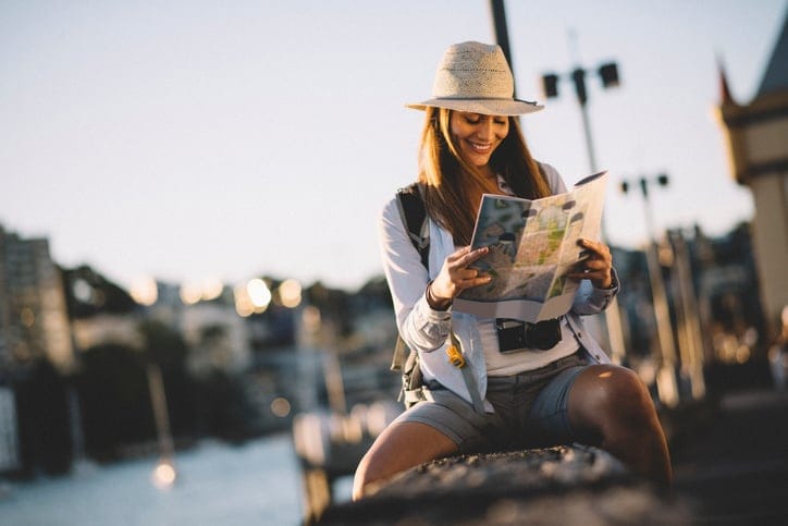 Tourist focusing on a city map in the street.