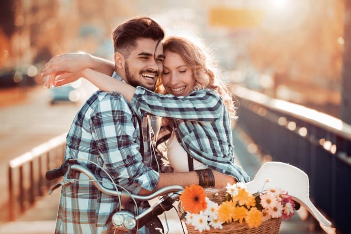 Couple riding their bikes in their free time and having fun on a sunny summer day.