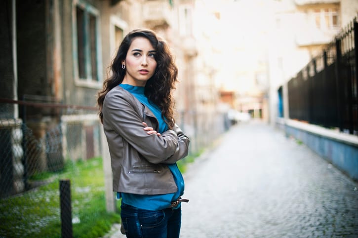 Alone, pensive young woman walking in the back streets.