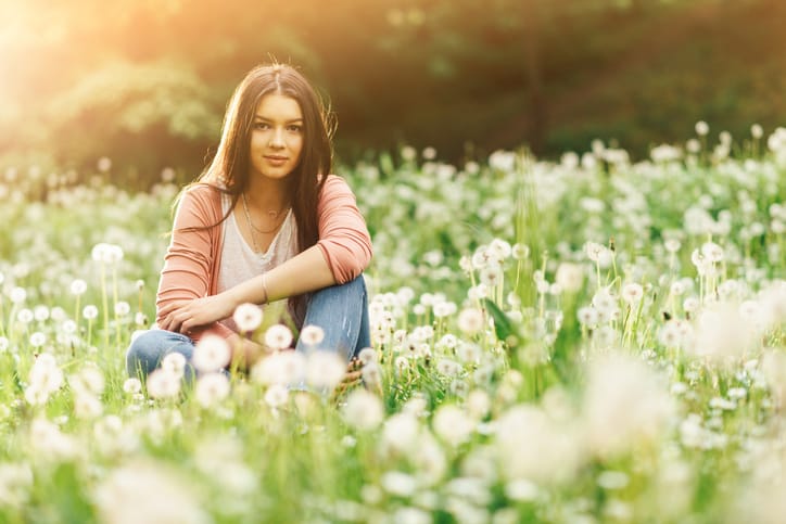 Portrait of healthy woman enjoying sunny spring day in nature
