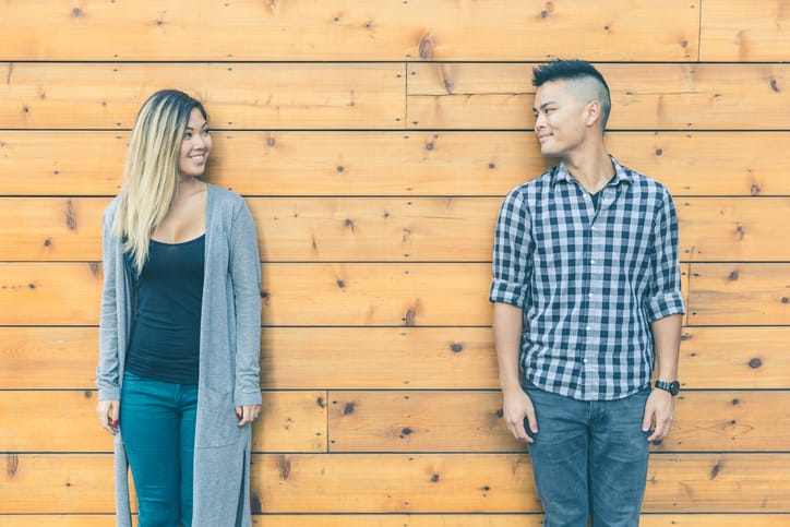 Asian couple portrait against wood background