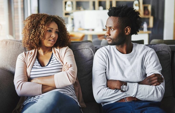 young black couple arms crossed