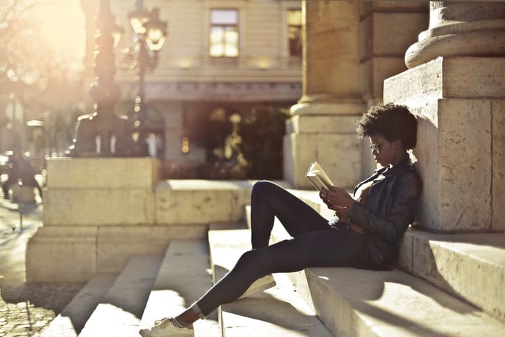 woman reading city outdoors sun