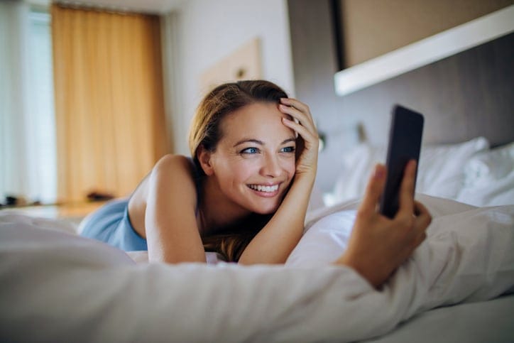 Close up photo of a young woman using a smart phone