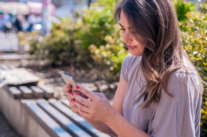 girl text park bench