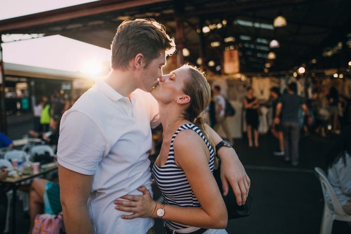 Happy couple kissing in Australian public market.