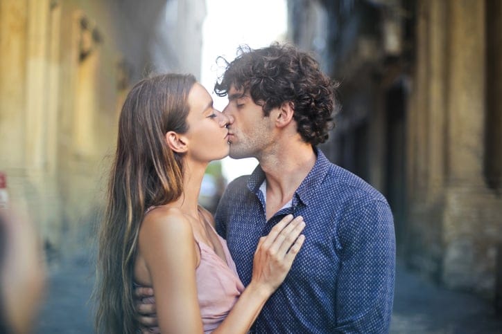In love couple tenderly kissing in the street