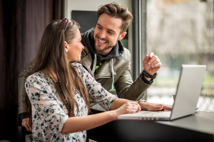 couple laughing and joking in a cafe