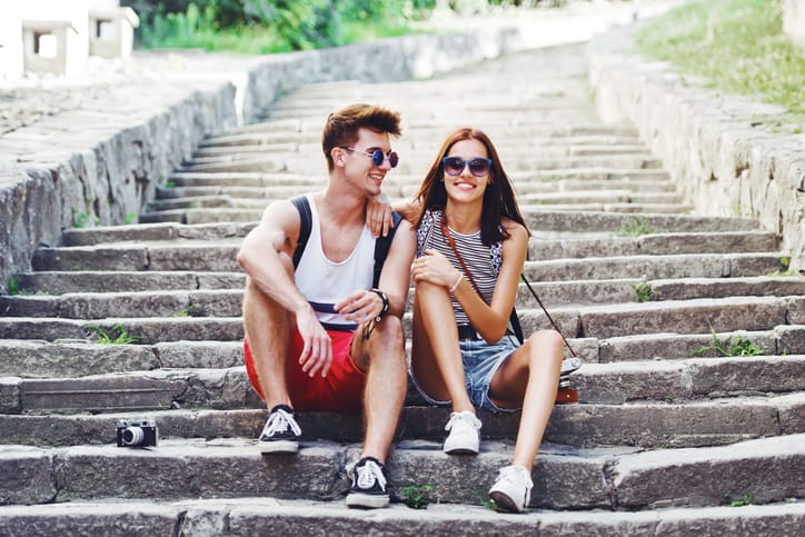 Two young tourists taking a break on an old stairway.