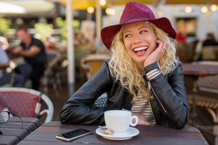 Woman sitting in cafe and laughing