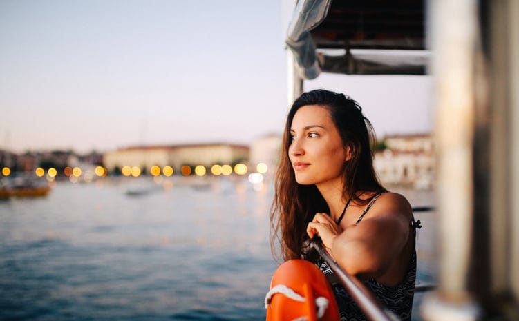 Young woman relaxing on the sailboat in Rovinj