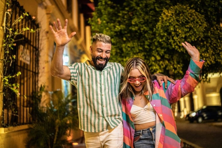 hipster couple dancing on city streets