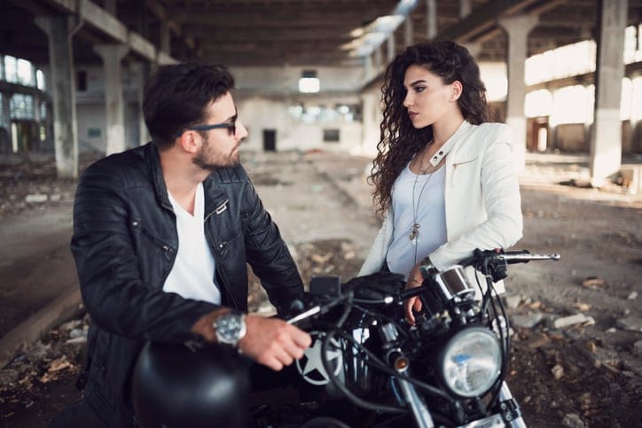 Man and a woman bikers flirting.
