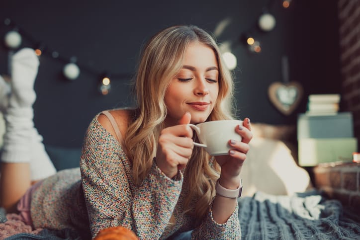 Young woman having a hot drink